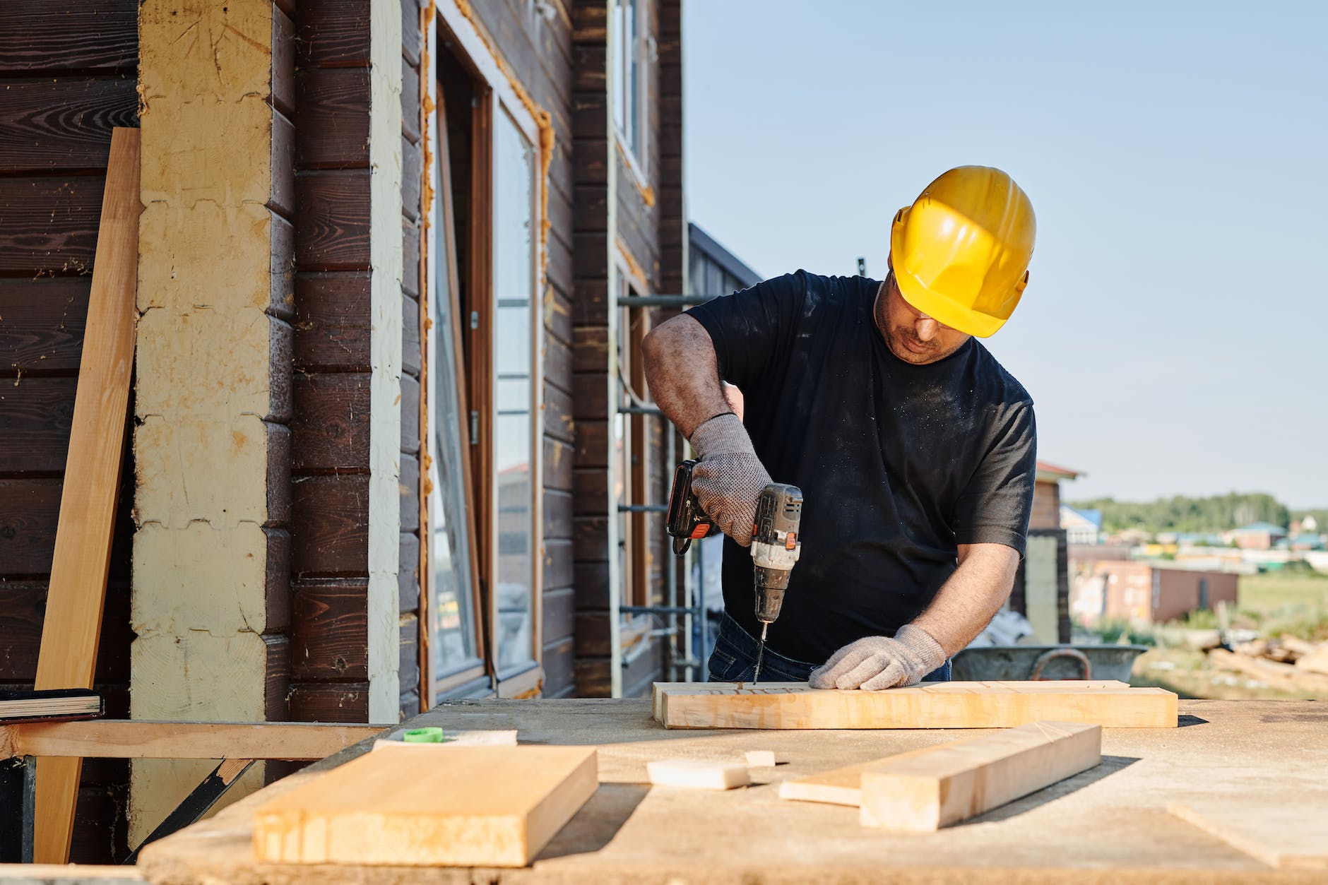 man in black shirt holding black power tool